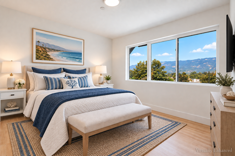 A bedroom with a large bed and a view of the mountains.