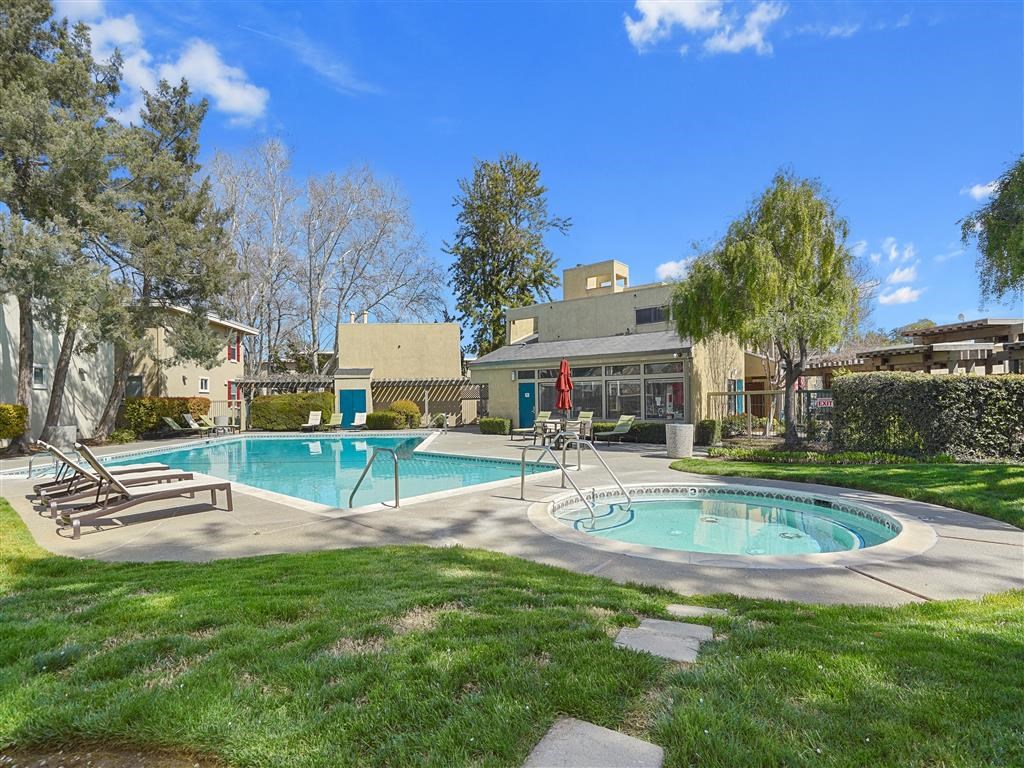 green grass surrounding pool and spa at Parkside Apartments, California