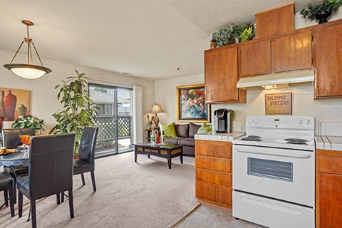 a kitchen and living room with a white stove