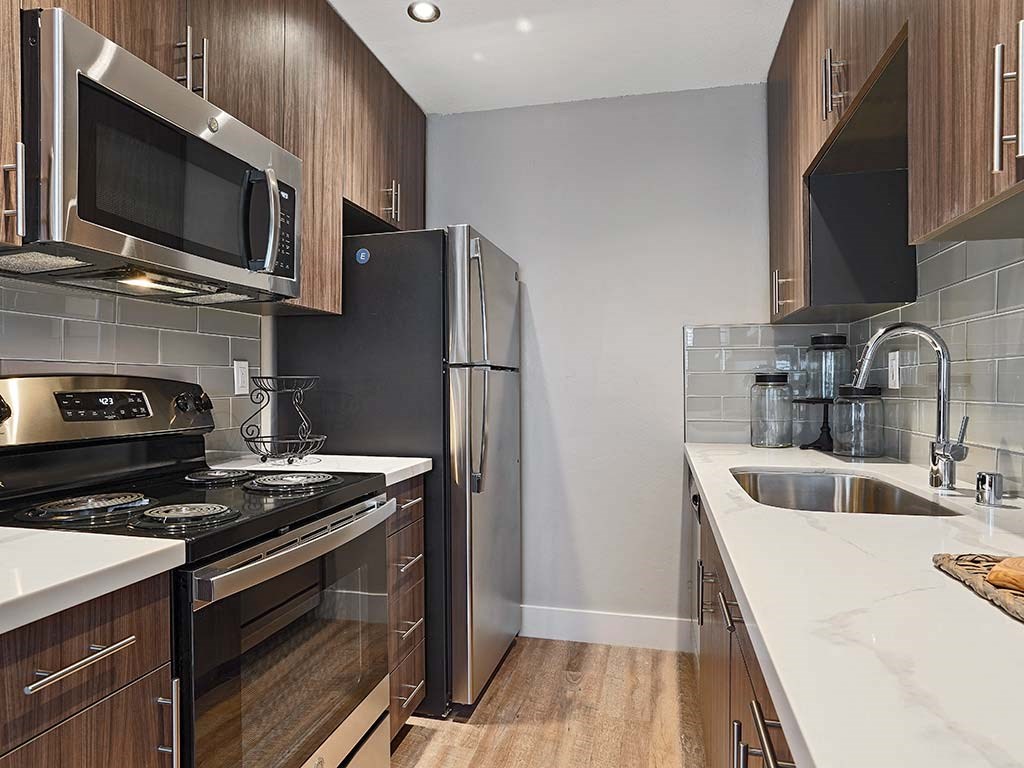Fully Equipped Kitchen Includes Frost-Free Refrigerator, Electric Range, & Dishwasher at Fairmont Apartments, Pacifica