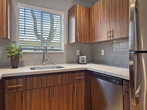 a kitchen with wooden cabinets and a sink and a refrigerator