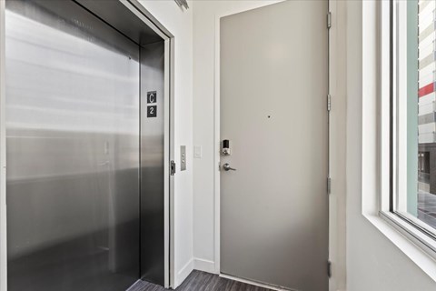 A stainless steel elevator with the numbers 2 and 3 on the side.