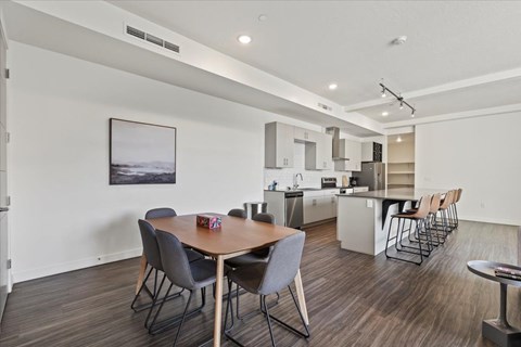 A modern kitchen with a dining table and chairs.