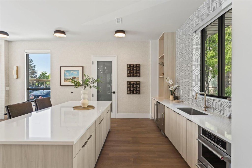 A modern kitchen with a white countertop and wooden cabinets. at Siena Villas Apartments, Orem, 84097