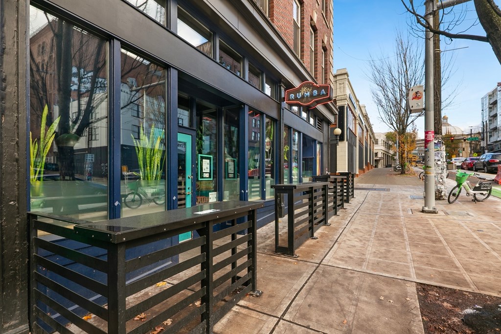 A sidewalk runs along the front of a building with a red sign that says "Kumari" on it.