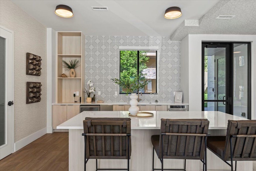 A kitchen with a white countertop and brown chairs. at Siena Villas Apartments, Orem, 84097