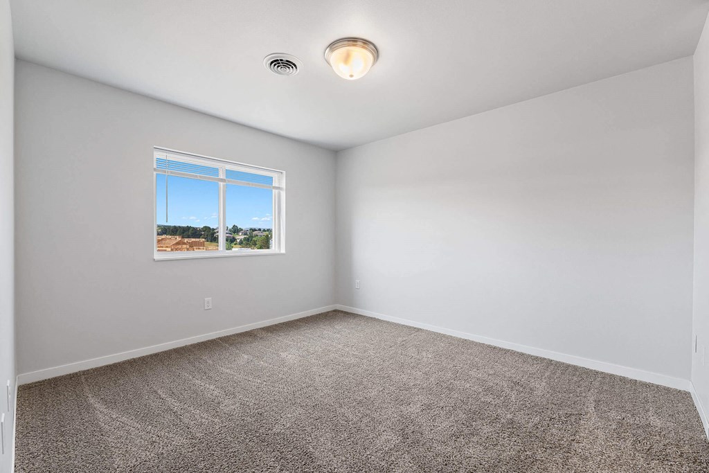 A room with a window and a ceiling light. at Red Rock Apartments, South Dakota 57702