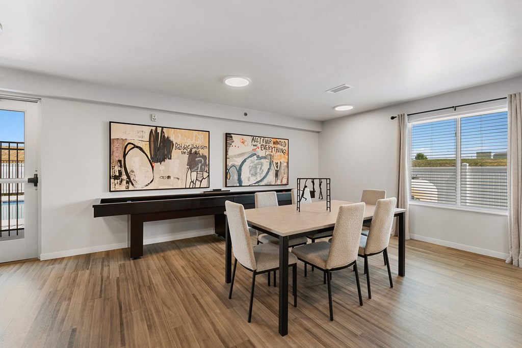 a dining room with a table and chairs and a window at Red Rock Apartments, Rapid City, SD