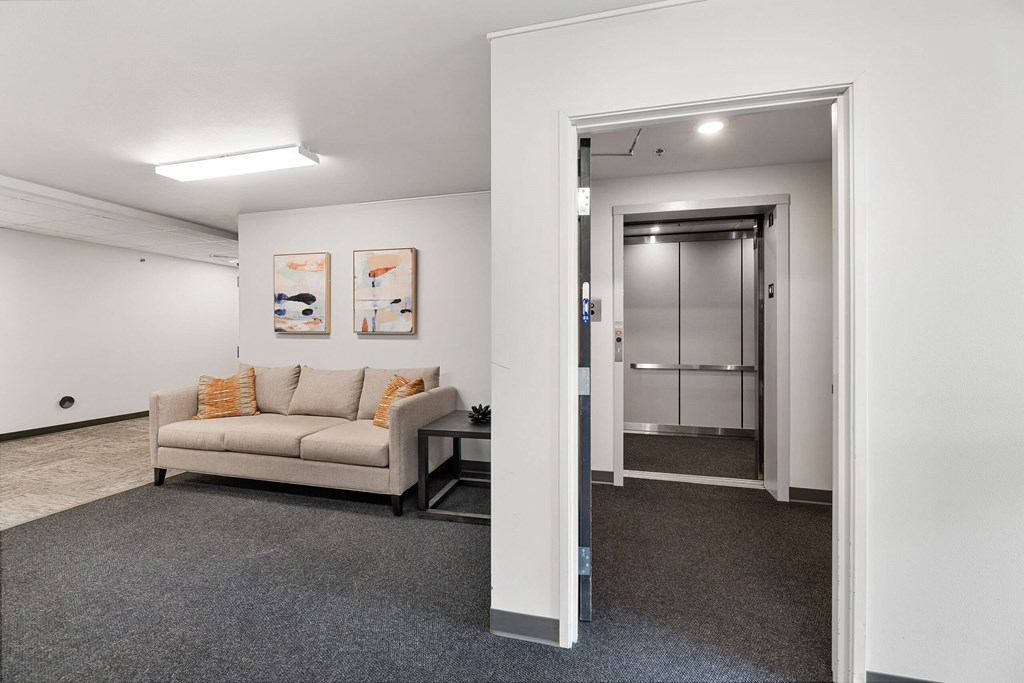 a living room with a couch and a glass door at Red Rock Apartments, Rapid City, 57702