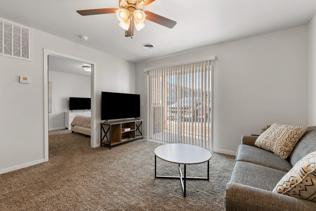 a living room with a couch and a coffee table and a tv at Red Rock Apartments, Rapid City, South Dakota