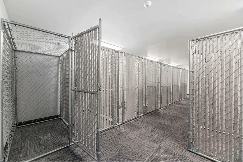 a row of metal cages in a white room at Red Rock Apartments, Rapid City, South Dakota