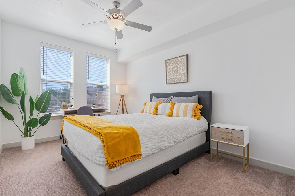 a bedroom with a bed and a ceiling fan a bedroom with a bed and a ceiling fan at City View St. George Apartments, Utah