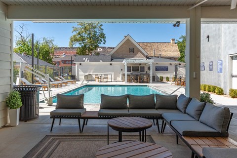 a swimming pool is seen from a patio with couches and tables at City View St. George Apartments, Utah, 84770