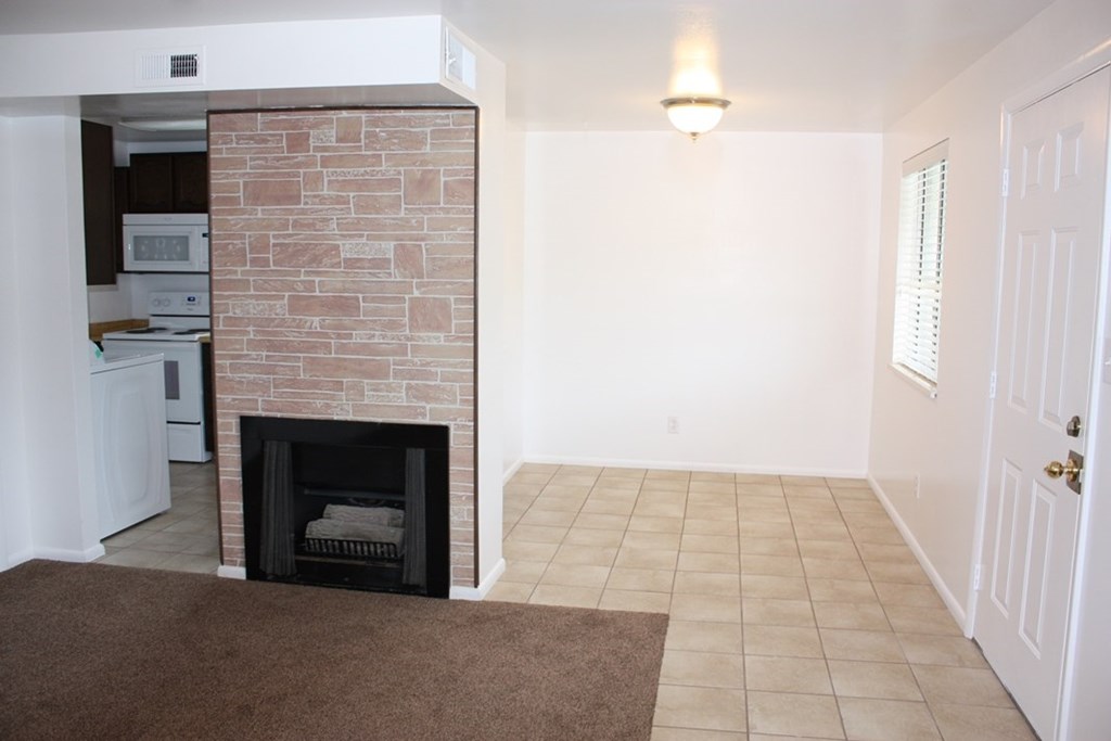 A room with a fireplace and a door.