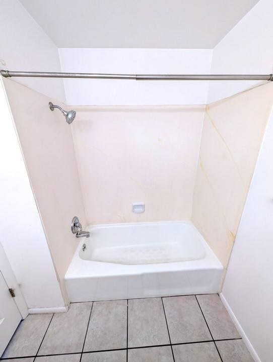 A white bathroom with a tub and shower.