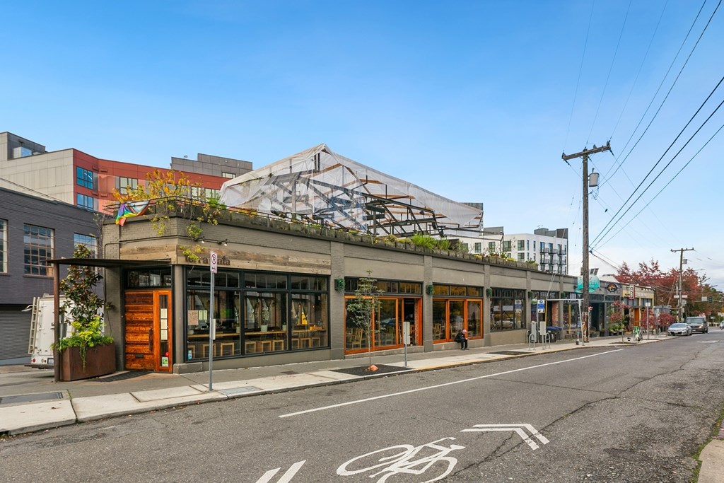 A street view with a bike lane and a building with a mural on the side.