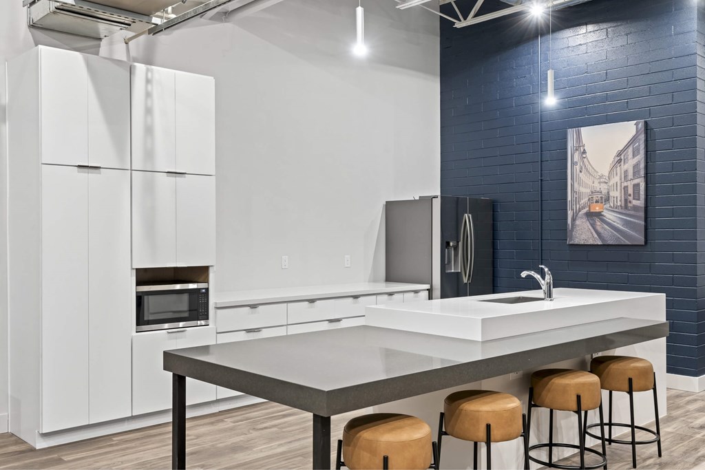 A modern kitchen with white cabinets and a grey countertop. at Brickside Heights, Millcreek, UT