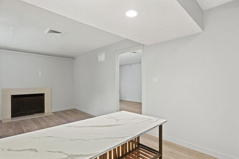 a living room with a marble table and a fireplace at AVIA Lofts on Liberty Ridge Apartments, Jacksonville 32256