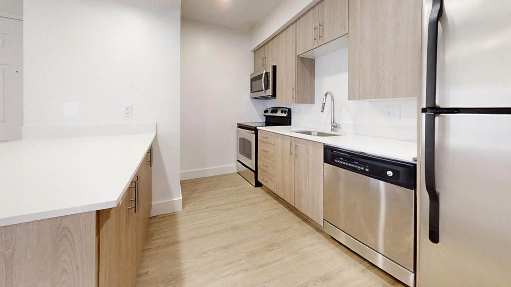 a large kitchen with wooden cabinets and stainless steel appliances