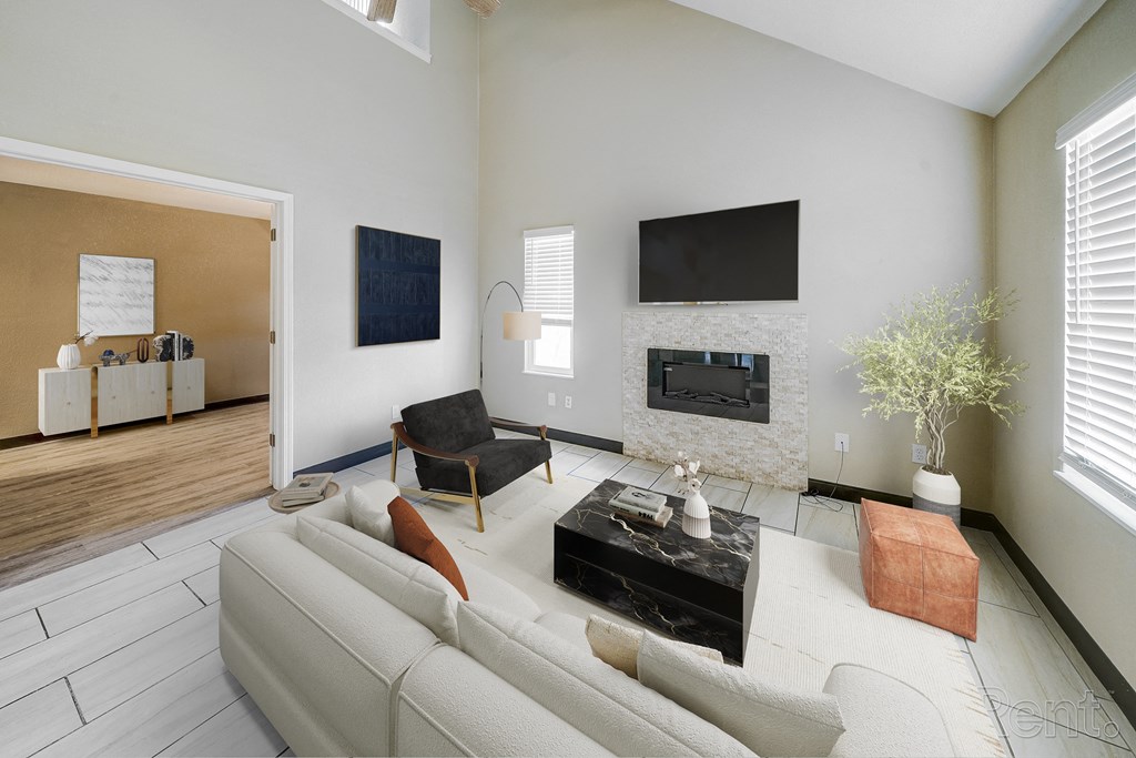 A living room with a white couch and a fireplace.