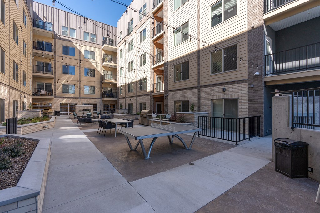 a communal patio with tables and chairs in an apartment building at The Revival, Salt Lake City, Utah