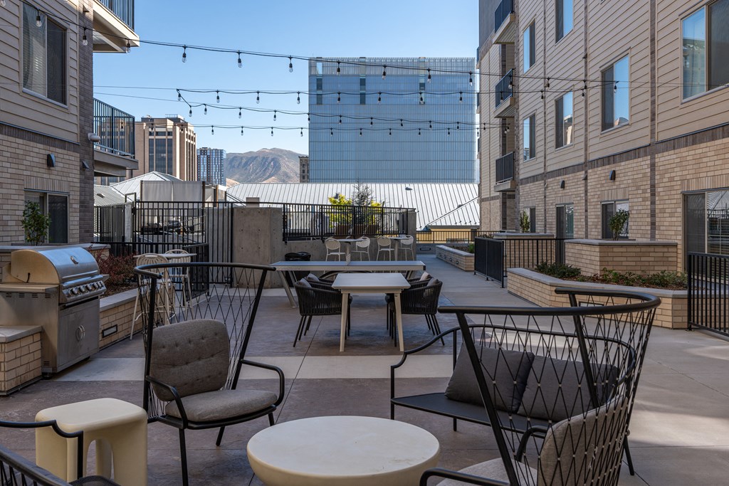 a rooftop patio with tables and chairs and a grill at The Revival, Salt Lake City