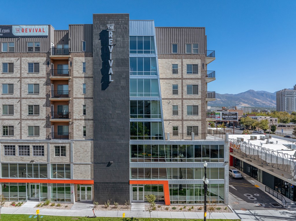 an aerial view of a tall building with a sign on the side of it at The Revival, Salt Lake City, Utah