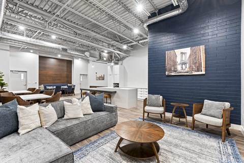 A modern living room with a grey sofa and wooden coffee table.