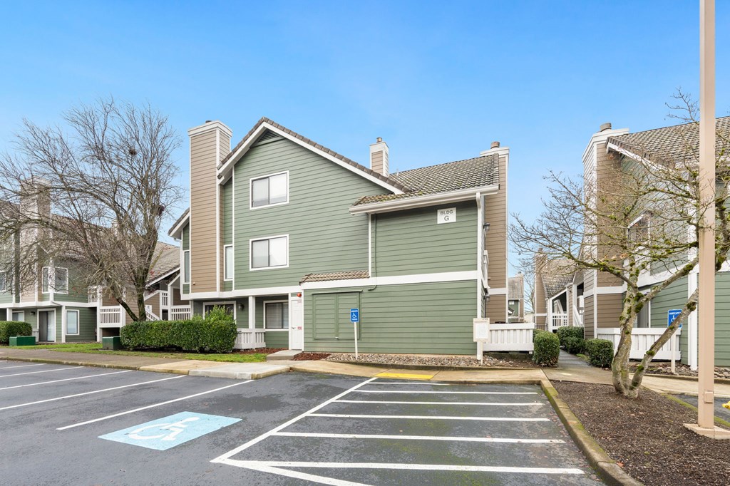 A parking lot with a blue painted handicap spot. at AVIA Lofts on Parkway Apartments, Vancouver, 98662