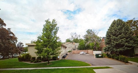 A residential street with houses and trees.