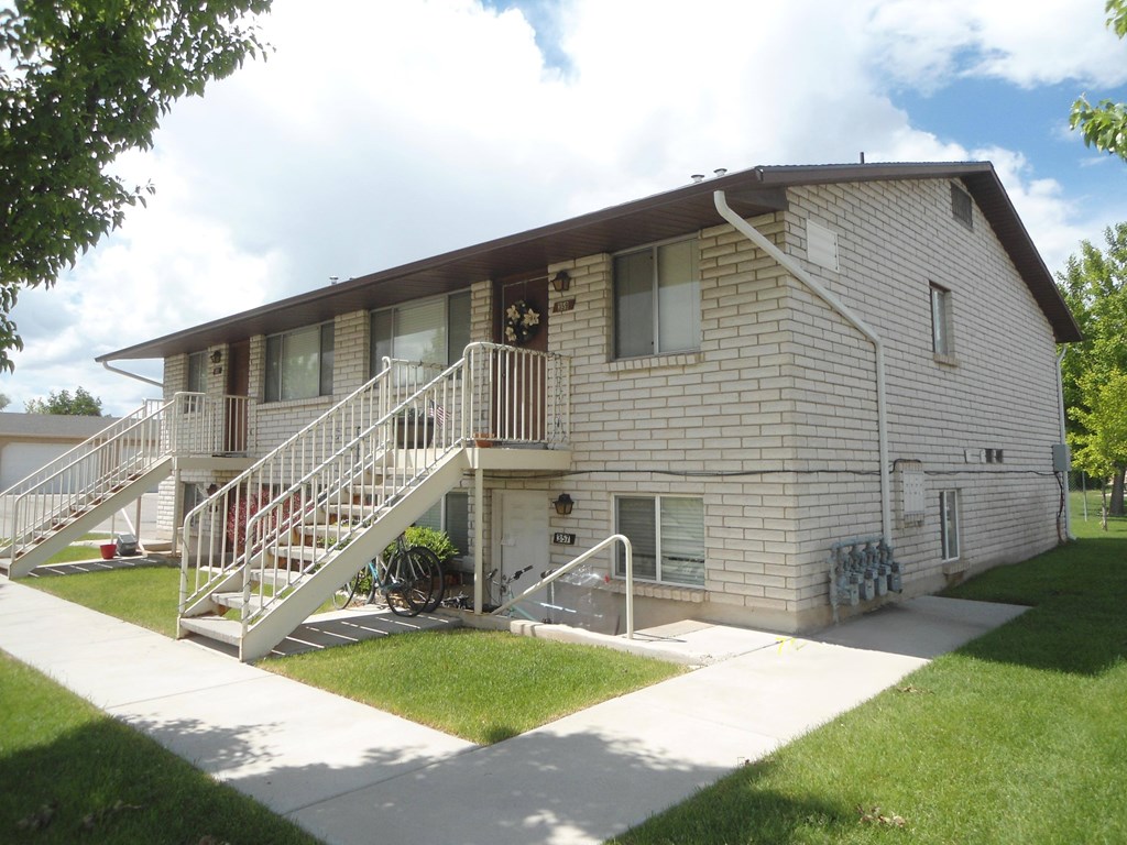 A two-story house with a white staircase and a small front porch.
