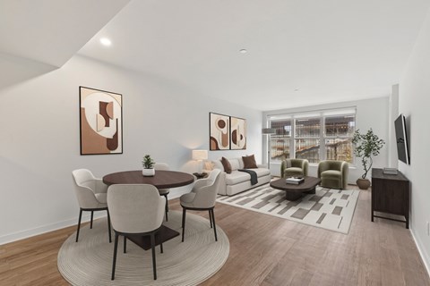 A modern living room with a dining table and chairs.