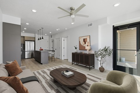 A modern living room with a brown coffee table and a brown couch.