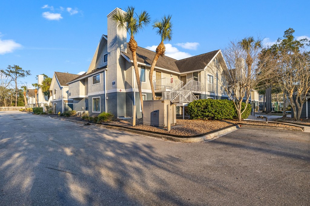 a row of houses with palm trees in front of them