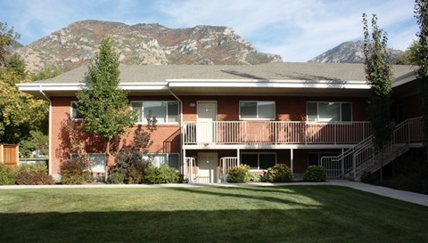 A red brick building with a mountain in the background.