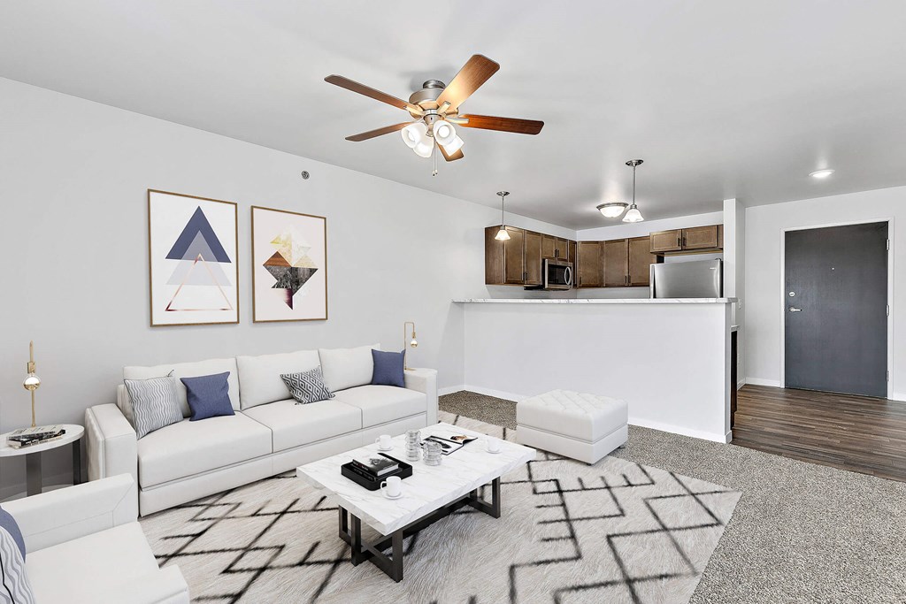 a living room with white couches and a coffee table at Red Rock Apartments, Rapid City, South Dakota