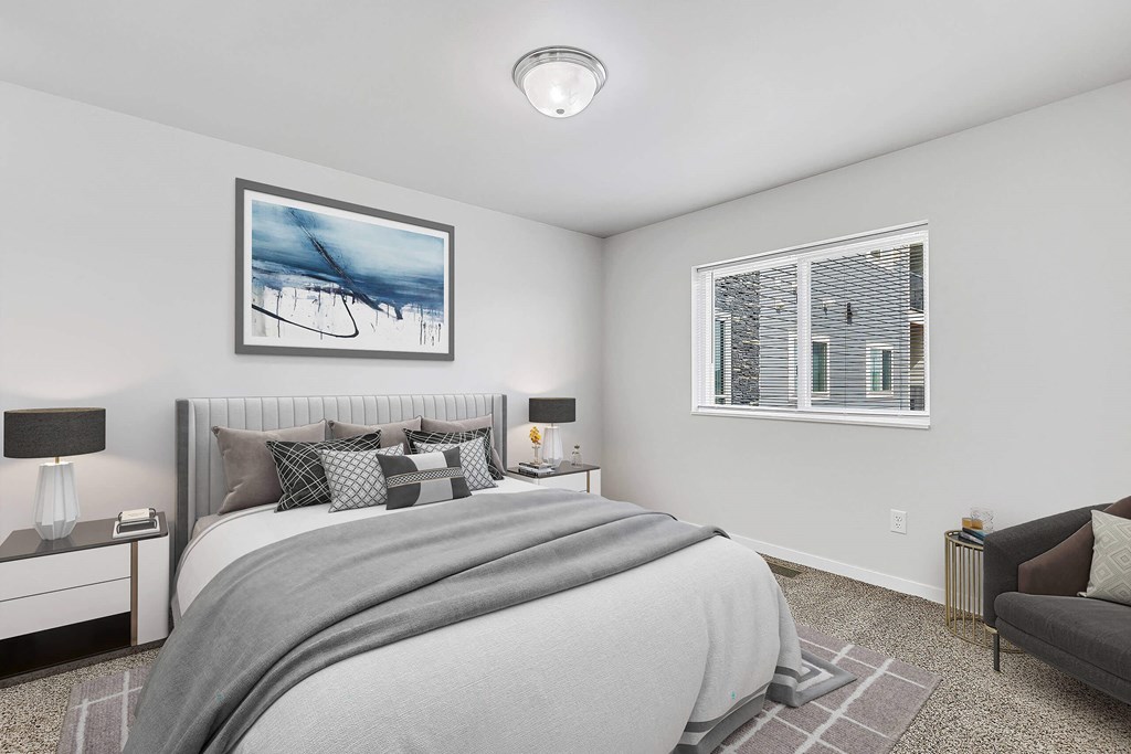 a bedroom with a large bed and two windows at Red Rock Apartments, Rapid City, SD, 57702