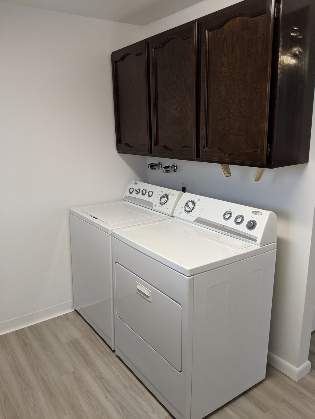 A white dishwasher and oven in a kitchen.