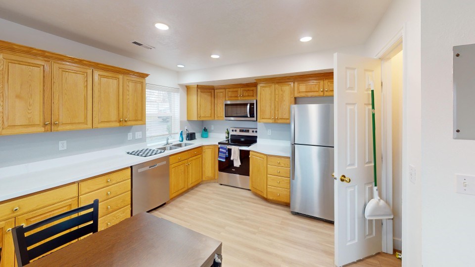 A kitchen with wooden cabinets and stainless steel appliances.