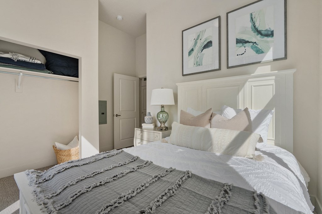 a bedroom with a bed and two pictures on the wall at 200 City View, Provo, UT