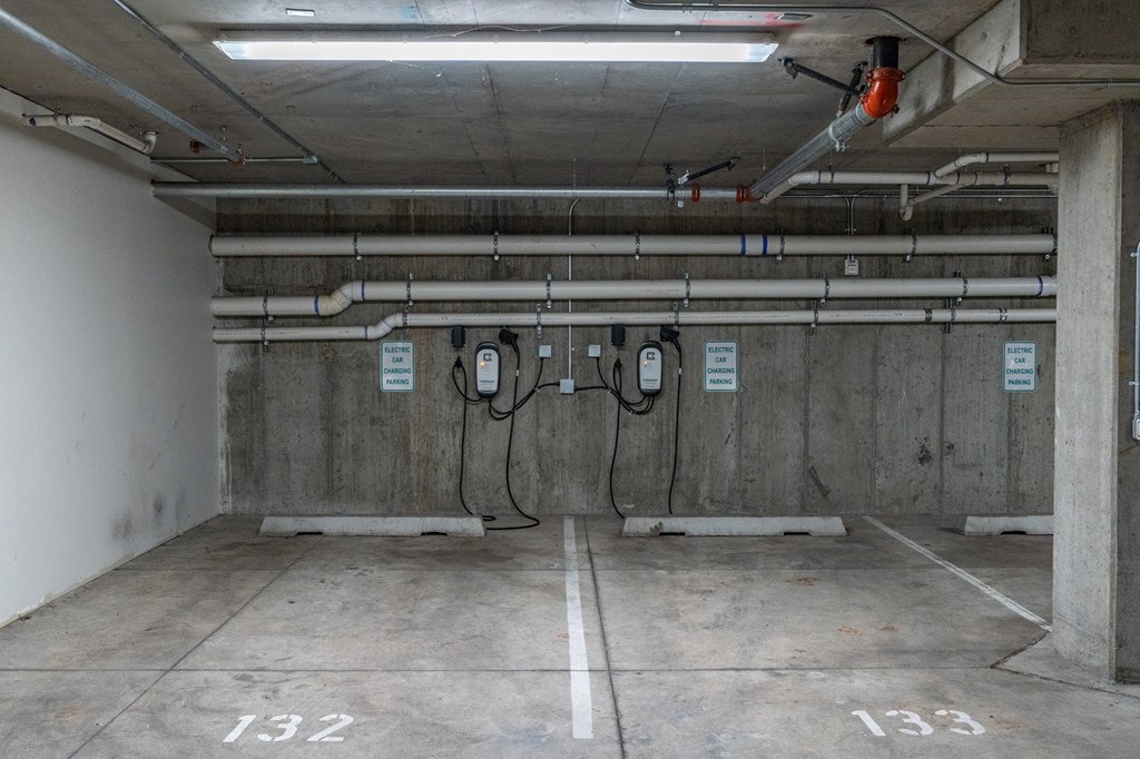 a room in a parking garage with pipes on the wall at 200 City View, Provo