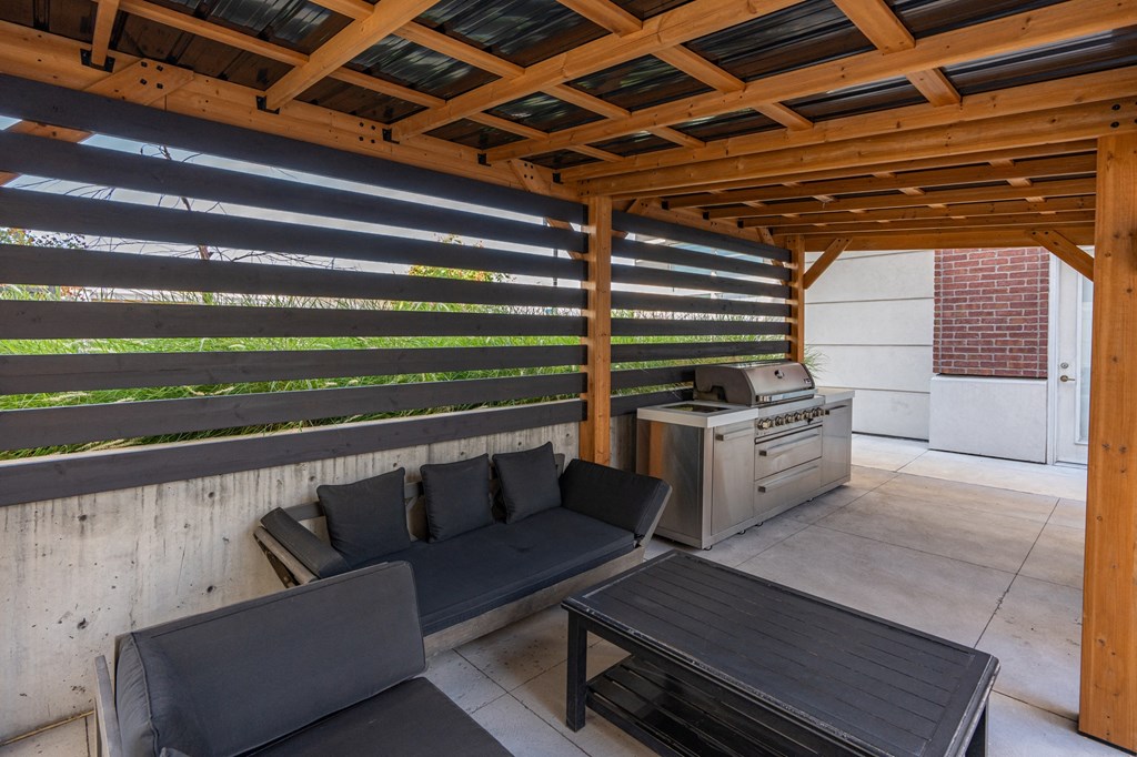 a covered patio with couches and a table at 200 City View, Utah