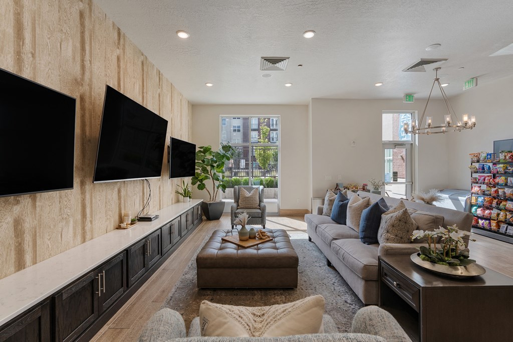a living room with a large couch and a tv at 200 City View, Provo, UT, 84601