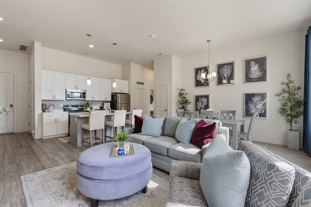 an open living room and kitchen with a couch and a table at 200 City View, Provo, 84601