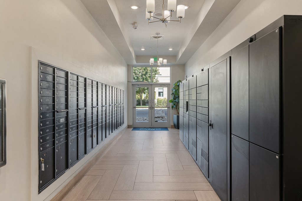 a long hallway with lockers and a door at 200 City View, Provo, UT