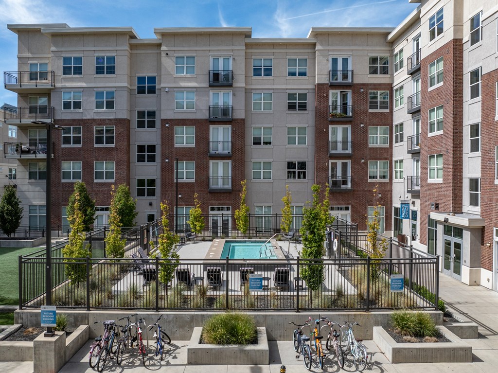 an apartment building with a pool and bikes parked in front of it at 200 City View, Provo, UT, 84601