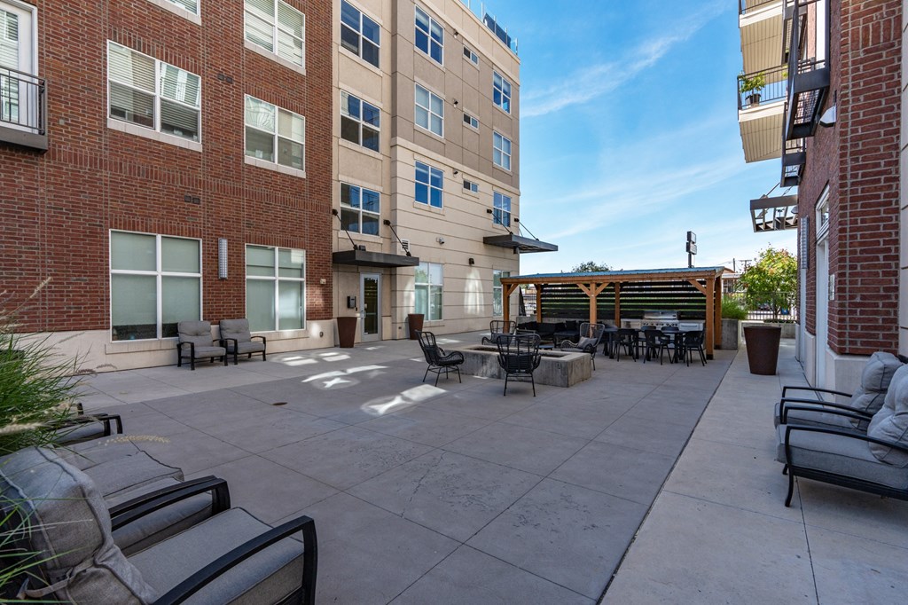 an outside patio with tables and chairs and a brick building at 200 City View, Provo, Utah