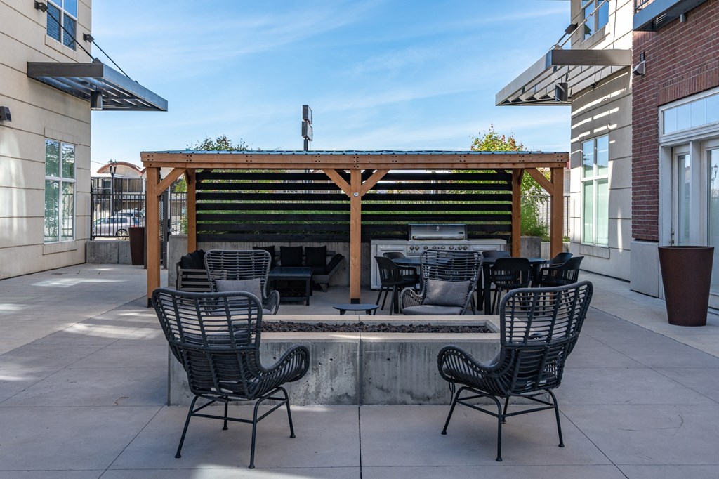 a patio with a fire pit and chairs and a wooden pergola at 200 City View, Provo, UT, 84601