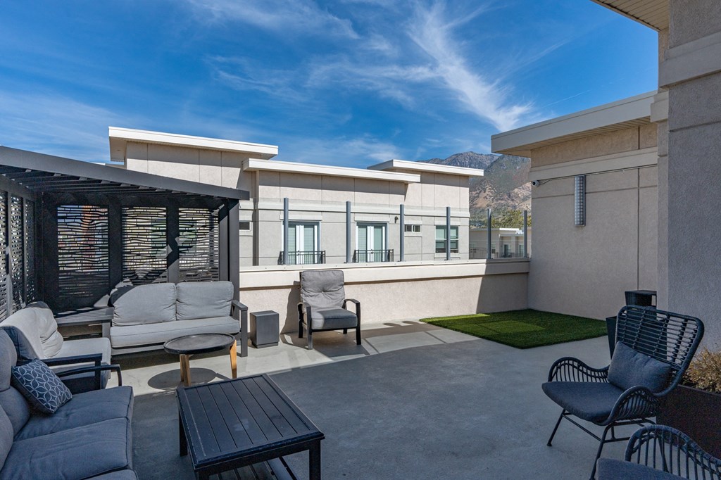 a patio with a couch and chairs and a table at 200 City View, Provo, 84601