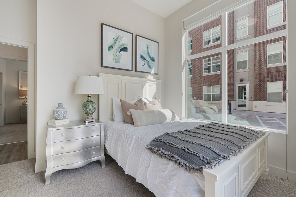 a bedroom with a bed and a large window at 200 City View, Provo